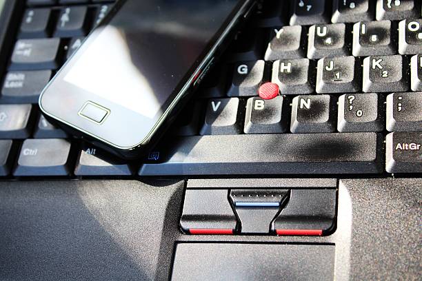 istock Smart phone on the keyboard of laptop 188069361
