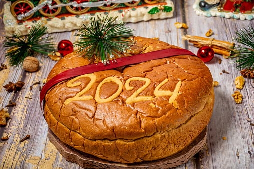 Traditional Greek new years cake, known as vasilopita, for 2024 and Christmas ornaments