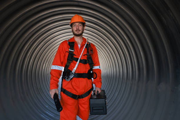 istock Portrait engineer or technician with reflective coverall suit and harness work in side hug tube 1880710197