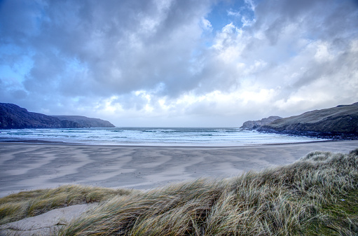 Stormy sky, patterned Sands and crashing waves on Cliff Beach Uig Isle of Lewis outer Hebrides western isles Scotland.