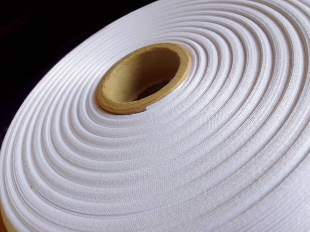 istock a roll of white ribbon on a black background 1880786351