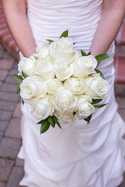 istock Bride Holding a Bouquet of White Roses 188080212