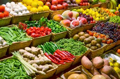 Close up of red and yellow bell peppers on a fruit and vegetable stall