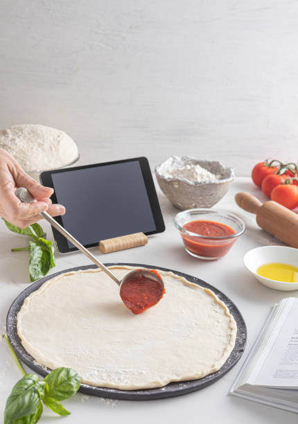 istock Raw dough for pizza with ingredient: tomato sauce, dough, mozzarella, tomatoes, basil, olive oil, spices served on rustic marble table 1880829552