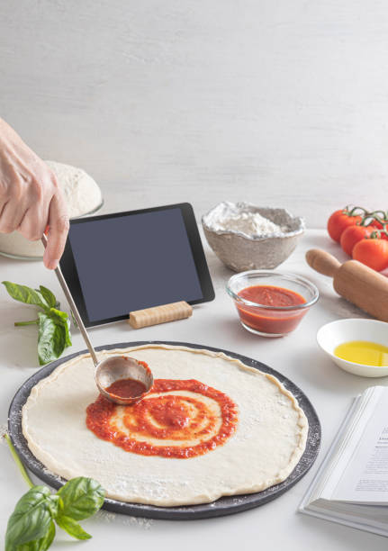 istock Raw dough for pizza with ingredient: tomato sauce, dough, mozzarella, tomatoes, basil, olive oil, spices served on rustic marble table 1880830085