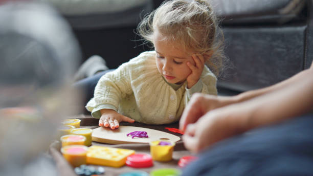 istock Kid play with plasticine at home. Family time. 1880834514
