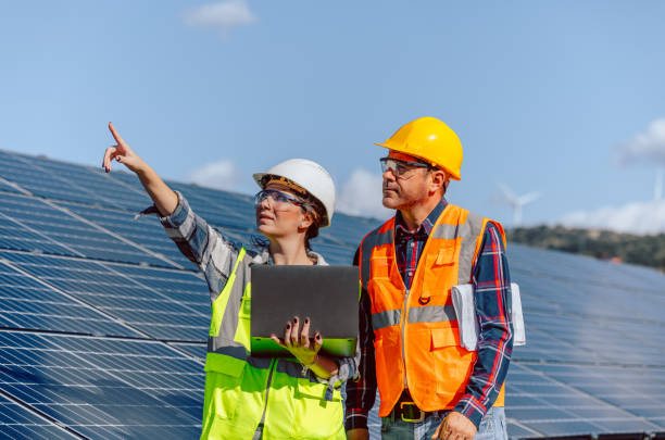 istock Young maintenance engineer team working in solar energy farm at sunny day 1880864560