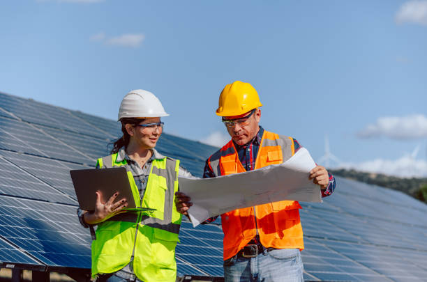 istock Maintenance engineer team working in wind turbine farm at sunset 1880865074