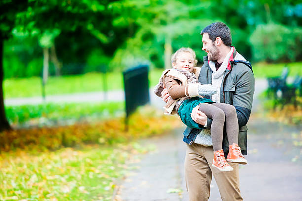 istock Father carrying his daughter in a London`s park 188087018
