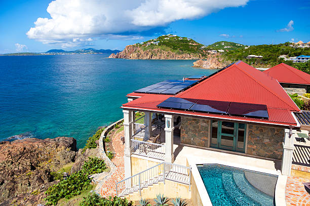 luxury Caribbean villa with alternative energy photovoltaic solar panels luxury Caribbean villa with alternative energy photovoltaic solar panels on roof st. thomas virgin islands photos stock pictures, royalty-free photos & images
