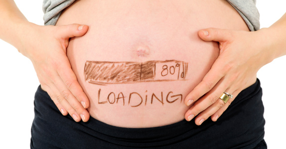 pregnant woman tummy with loading message on it.