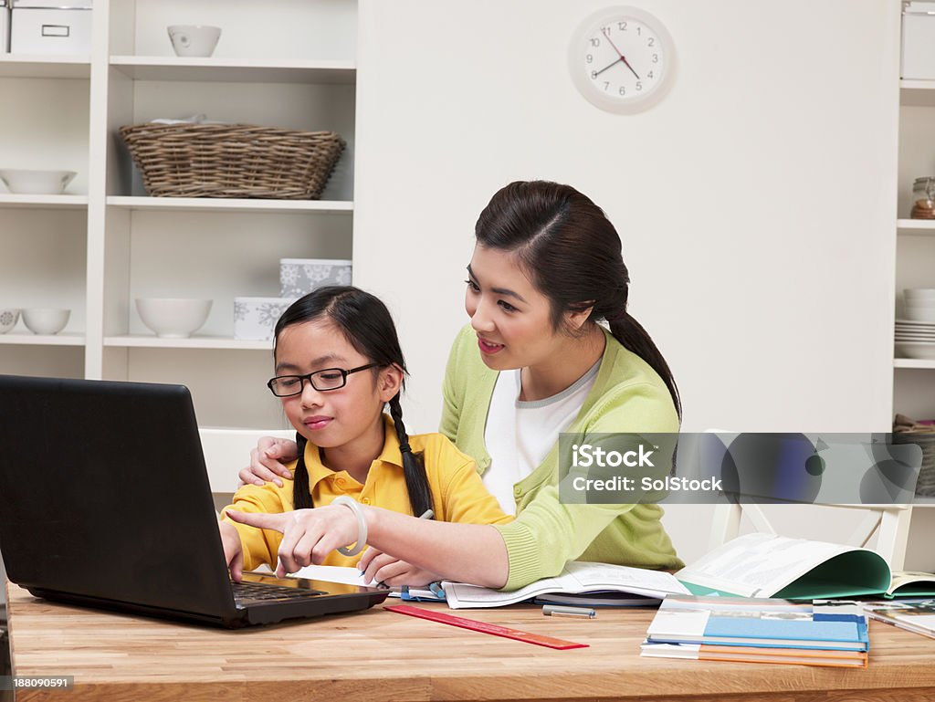 Homework Time Asian family doing homework together Chinese Ethnicity Stock Photo