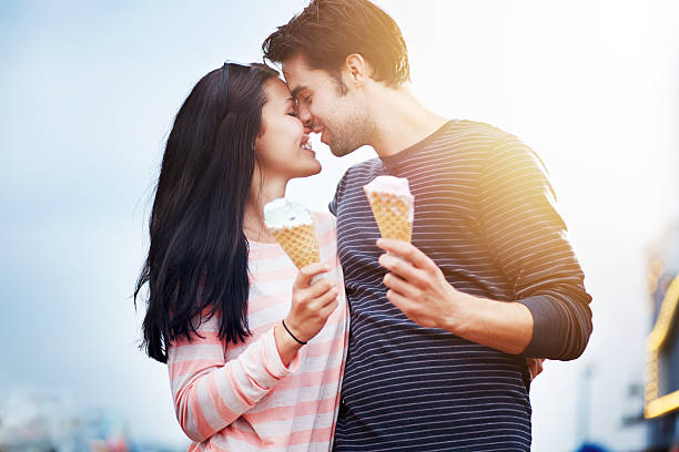 istock romantic couple with ice cream at amusement park 188092699