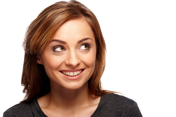 istock Beautiful young woman looking away at copyspace smiling 188094040