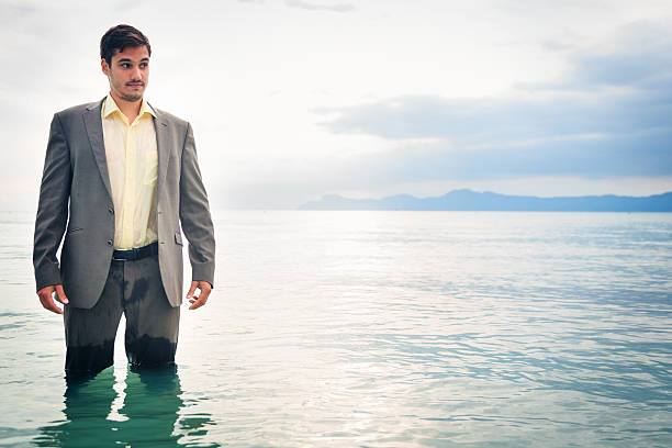 istock businessman knee-deep in water 188094087