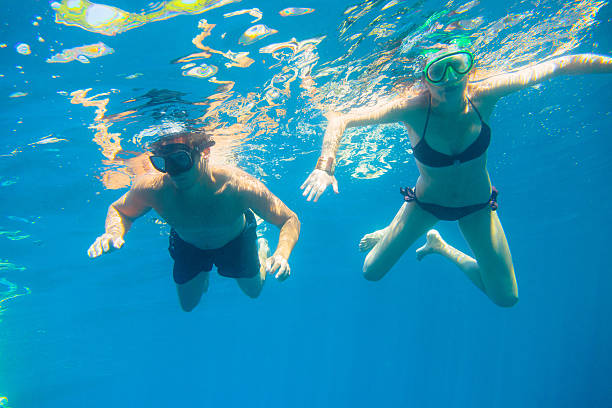 istock young couple snorkeling 188094711