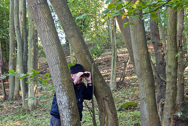 istock Man with binoculars in a wood 188099325