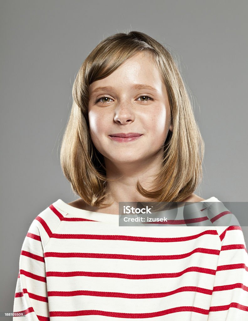 Happy girl Portrait of beautiful girl wearing striped blouse smiling at camera, Studio shot, grey background. Girls Stock Photo