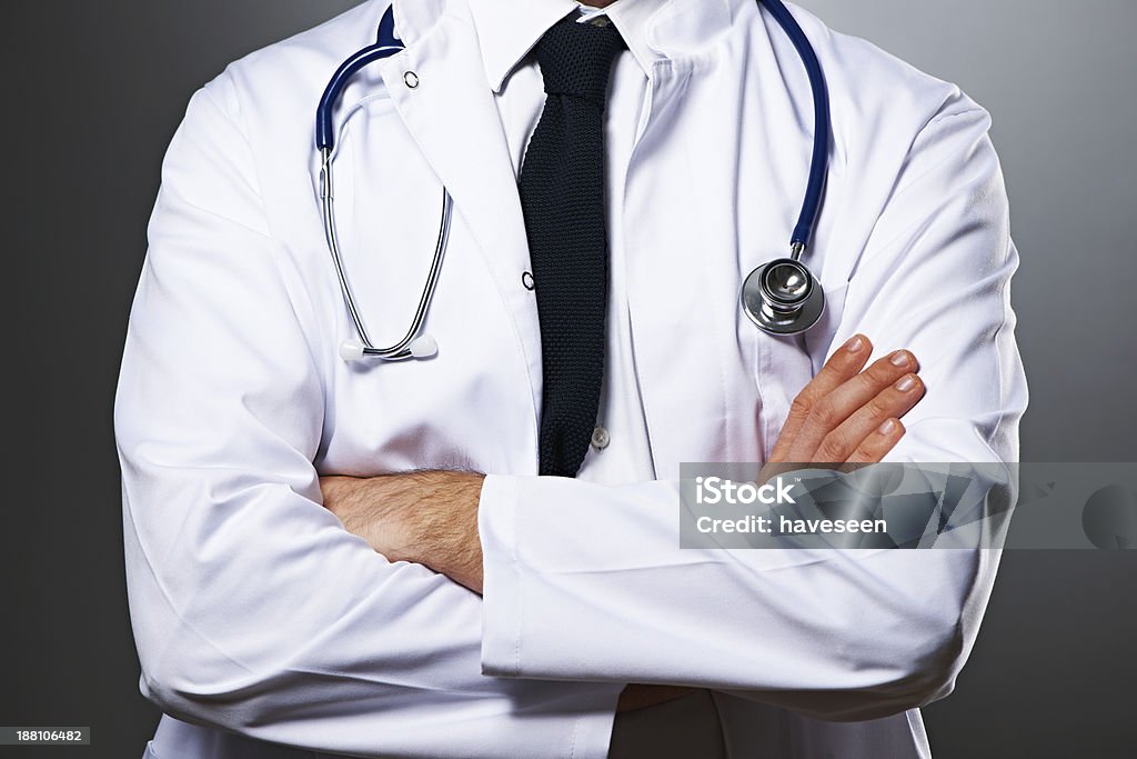 Medical doctor with stethoscope portrait Medical doctor with stethoscope portrait against grey background 20-29 Years Stock Photo