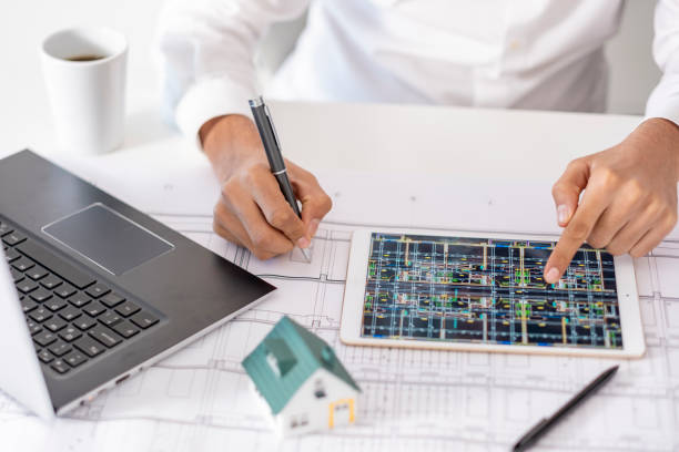 istock real estate agent or architect explains the housing project to his client online 1881117923