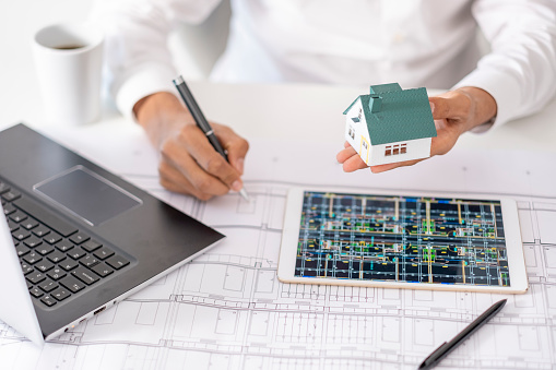 real estate agent or architect explains the housing project to his client online