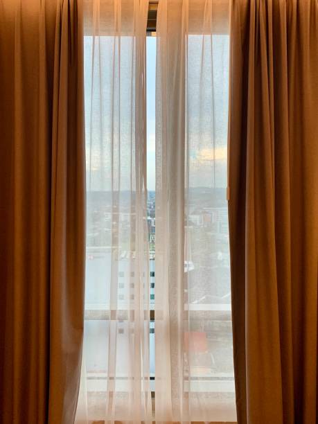 istock Hotel room morning city view through curtain 1881129806