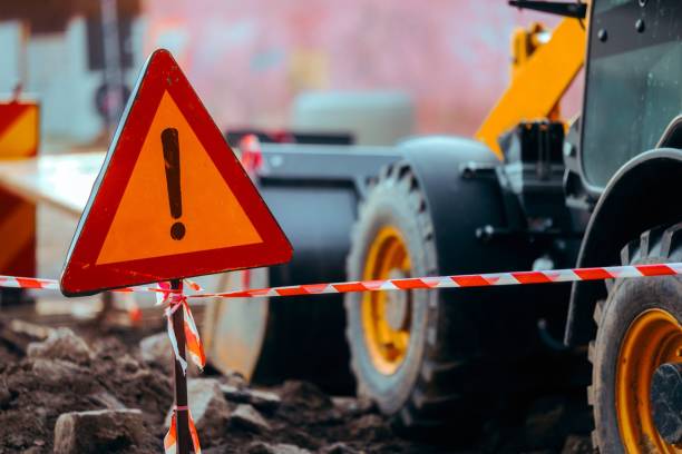 istock Excavator on Construction Site Marked by Warning Sign 1881152120