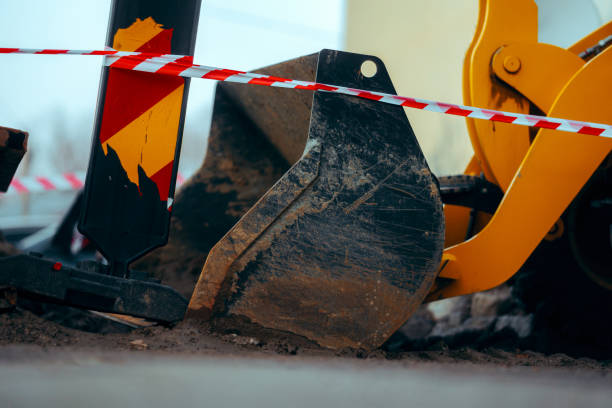 istock Excavator Behind a Warning Tape on a Construction Site 1881152632