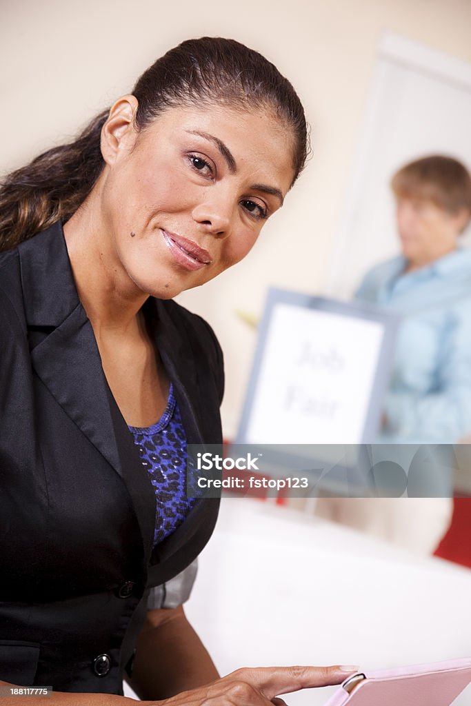 Business:  Unemployed woman registers for Job Fair on digital tablet. Unemployed, hispanic woman registers for a local Job Fair using her digital tablet. Adult Stock Photo