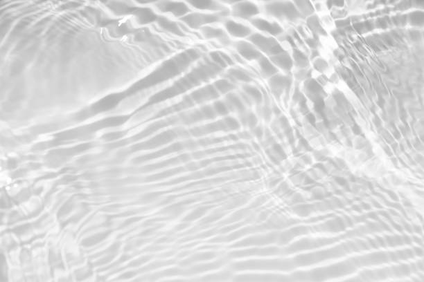 istock White water with ripples on the surface. Defocus blurred transparent white colored clear calm water surface texture with splashes and bubbles. Water waves with shining pattern texture background. 1881239543