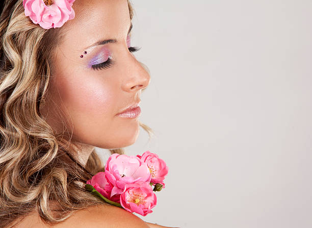 istock beautiful face with pink roses 188124028