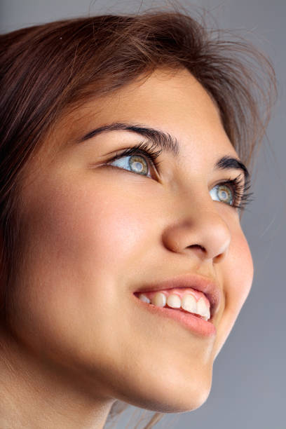 inverted portrait of a young lying blond smiling woman on a white background