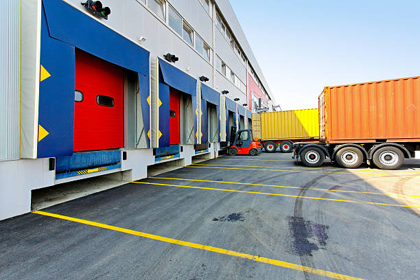 Forklift loader Forklift and trucks at cargo dock of warehouse. loading bay stock pictures, royalty-free photos & images