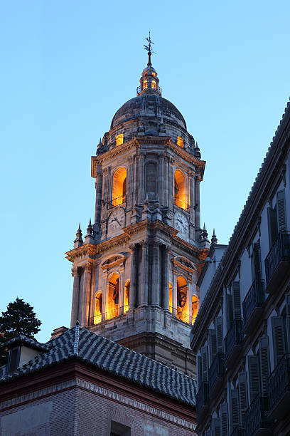Malaga cathedral tower illuminated at dusk. Andalusia, Spain