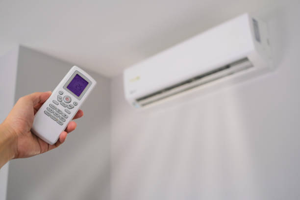 istock Man's hand using remote control open The air conditioner is cooled to 25 degrees Celsius in his bedroom. Health concepts and energy savings 1881284412