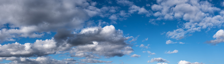 Cumulus clouds appear in a blue sky over Kachina Wetlands near Flagstaff, Arizona, USA.