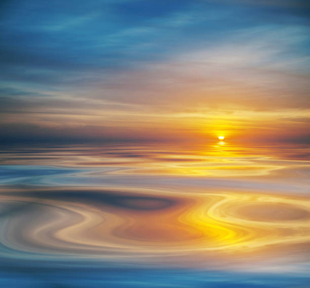 istock Cloudy sunset or sunrise reflected on calm water 1881339159