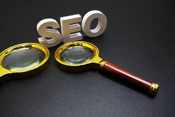 istock SEO (search engine optimization) text message with magnifying glass on black background 1881349431