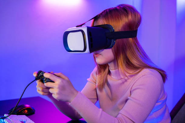 istock Gamer in VR headset glasses exploring metaverse play video game online with joystick 1881372785
