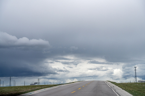 Cloudy weather, A road on the plateau lead to distant mountains