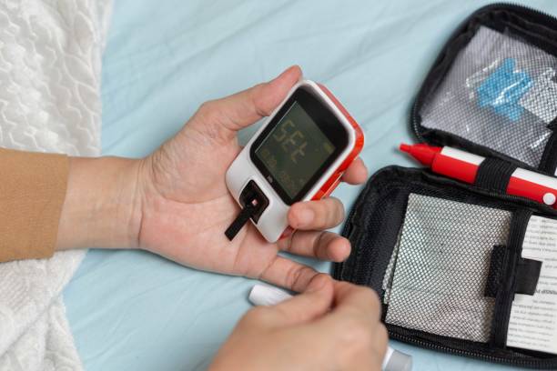 istock A woman's hand checking her blood sugar level with a glucometer by herself at her home. 1881379524