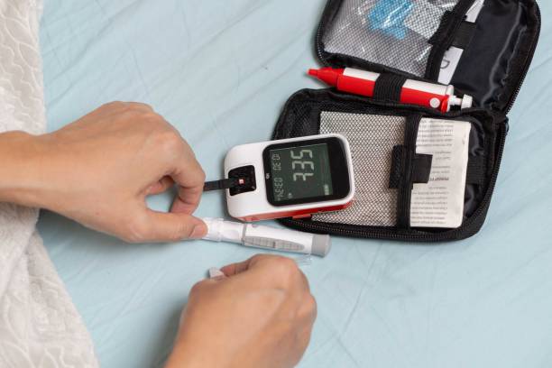 istock A woman's hand checking her blood sugar level with a glucometer by herself at her home. 1881380050