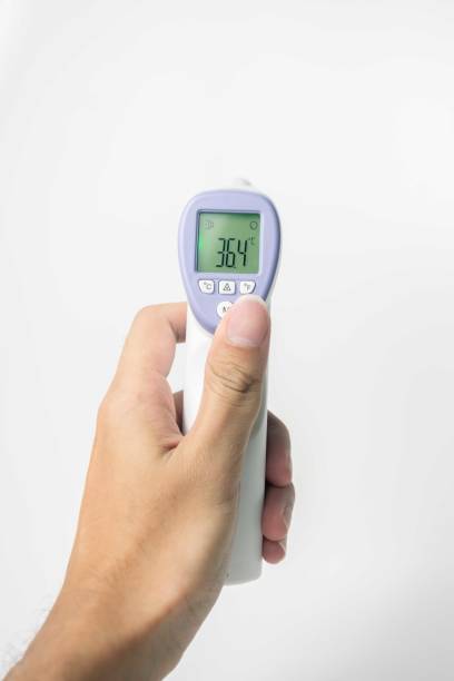 istock hand holding digital infrared thermometer isolated on white background. with copy space 1881387799