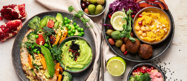 istock Vegan tasty hummus, herb hummus, beetroot hummus on a light wood background. 1881396054