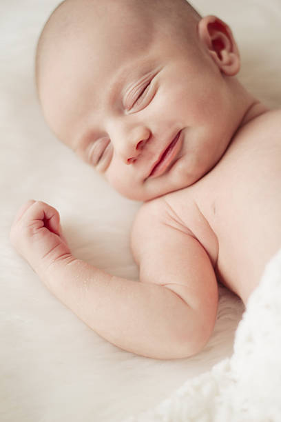 istock Smiling newborn baby sleeping 188143544