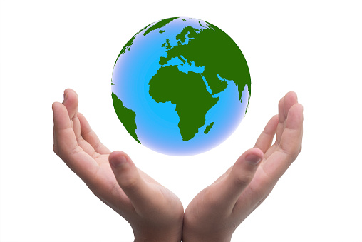 Hand holding the earth. Globe ,earth in human hand, holding our planet glowing, World Earth Day Concept. Green Energy, Environmental protection concept.