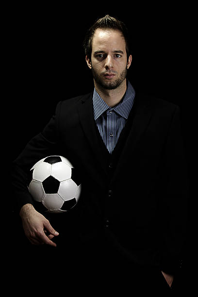 istock businessman holding a soccer ball (football) 188145442