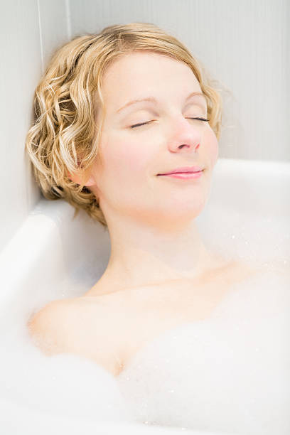 istock Young woman relaxing in the bath 188146112