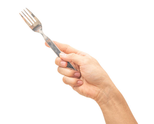 istock isolated of a man's hand holding a silver steel fork. 1881481967