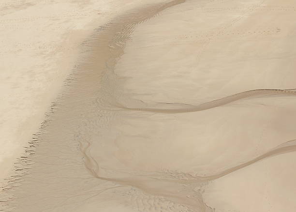 Water Draining from Beach stock photo